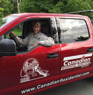 home inspector sitting in logoed truck